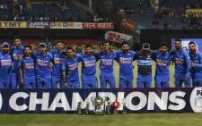 India's cricketers pose for a team photograph with the trophy after winning the third and last one day international (ODI) cricket match of a three-match series between India and Australia at the M. Chinnaswamy Stadium in Bangalore on 19 January 2020. Picture: AFP