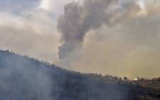 Smoke billows from a wildfire in the forested hills of the Kabylie region, east of the capital Algiers, on 10 August 2021. Picture: Ryad Kramdi/AFP
