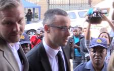 Oscar Pistorius is escorted into the High Court in Pretoria ahead of his murder trial on 5 May 2014. Picture: Christa Eybers/EWN.