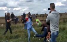 In the footage, which spread rapidly earlier this week, Petra Laszlo can be seen tripping a man with his child. Picture: Sad Day to be a Human via YouTube.