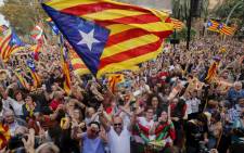 People celebrate after Catalonia's parliament voted to declare independence from Spain in Barcelona on 27 October 2017. Picture: AFP.