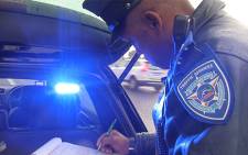 FILE: Traffic Officer who forms part of the Ghost Squad writing out a ticket in Cape Town.