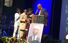 Mduduzi ‘Mandoza’ Tshabalala's widow Mpho stands on the podium with her three sons. Picture: Masego Rahlaga/EWN.