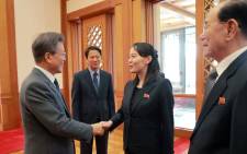 This picture taken on 10 February 2018 and released from North Korea's official Korean Central News Agency (KCNA) on 11 February 2018 shows South Korea's President Moon Jae-in (L) greeting North Korean leader Kim Jong Un's sister Kim Yo Jong (C) as North Korea's ceremonial head of state Kim Yong Nam (R) looking on before their meeting at the presidential Blue House in Seoul. Picture: AFP.