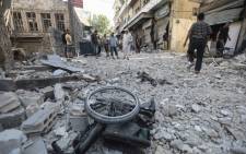 FILE: A wheelchair is seen amid the rubble of destroyed buildings following a reported regime air strike on the town of Ariha, in the south of Syria's Idlib province, on July 24, 2019. Picture: AFP.