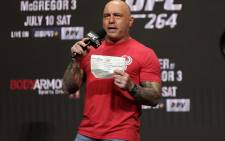 FILE: UFC commentator Joe Rogan announces the fighters during a ceremonial weigh-in for UFC 264 at T-Mobile Arena on 9 July 2021 in Las Vegas, Nevada. Stacy Revere/AFP