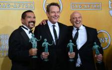FILE: Actors Steven Michael Quezada, Bryan Cranston and Dean Norris, winners of the Screen Actors Guild award for outstanding performance by an ensemble in a drama series award for 'Breaking Bad' in 2014. Picture: AFP.