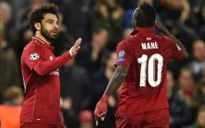 Liverpool's Egyptian midfielder Mohamed Salah celebrates with Liverpool's Senegalese striker Sadio Mane after scoring their second goal during the Uefa Champions League group C football match between Liverpool and Red Star Belgrade at Anfield in Liverpool, north west England on 24 October, 2018. Picture: AFP.