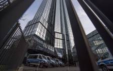 Police vehicles are parked at Deutsche Bank's headquarters in Frankfurt on 29 November 2018. German prosecutors raided several Deutsche Bank offices in the Frankfurt area over suspicions of money laundering based on revelations from the 2016 'Panama Papers' data leak. Picture: AFP