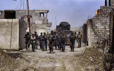 Members of the Iraqi federal police patrol the streets of Mosul as they advance on 26 February, 2017 during an operation to retake the city from Islamic State (IS) group fighters. Picture: AFP.