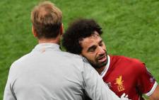 Liverpool's Egyptian forward Mohamed Salah (R) is comforted by Liverpool's German manager Jurgen Klopp as he leaves the pitch after injury during the UEFA Champions League final football match between Liverpool and Real Madrid at the Olympic Stadium in Kiev, Ukraine on 26 May, 2018. Picture: AFP.