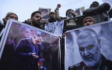 FILE: Protesters shout slogans against the United States and Israel as they hold posters with the image of top Iranian commander Qasem Soleimani, who was killed in a US airstrike in Iraq, and Iranian President Hassan Rouhani during a demonstration in the Kashmiri town of Magam on 3 January 2020. Picture: AFP.