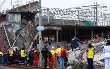 FILE: Rescuers search for construction workers still unaccounted for under the rubble at the Tongaat Mall. Picture: AFP.