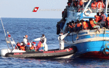 FILE: A video grab released by the Italian Coast Guards on 23 August 2015 shows migrants waiting on an overcrowded boat being helped during a rescue operation off the coast of Libya as part of the Frontex-coordinated Operation Triton. Picture: AFP. 