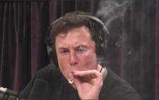 A screengrab of Tesla boss Elon Musk smoking marijuana.