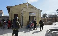 Pakistani security personnel rescue an injured woman after suicide bombers attacked a Methodist church during a Sunday service in Quetta on 17 December, 2017. Picture: AFP