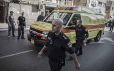 Israeli policemen escort an ambulance transporting Palestinian Nour Ab Hashye who allegedly stabbed an Israeli soldier after his arrest in Tel Aviv, Israel, 10 November 2014. Picture: EPA.