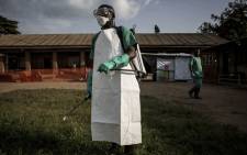 FILE: A hygienist is seen inside an Ebola Treatment Centre run by The Alliance for International Medical Action (ALIMA) on 12 August 2018, in Beni. Picture: AFP