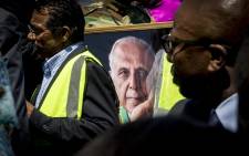 FILE: A portrait of struggle stalwart Ahmed Kathrada is carried with the procession as his coffin is taken to the grave at Westpark cemetery in Johannesburg on 29 March 2017. Picture: Reinart Toerien/EWN