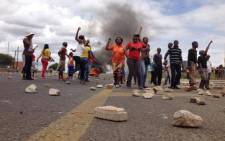 FILE: Protesters in Hebron blocked major roads with rocks and burned tyres during service delivery protests on 7 February 2014. Picture: Barry Bateman/EWN.