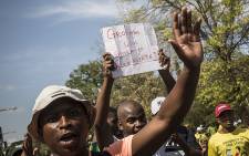 A student holds up a placard during demonstrations at the University of the Free State main campus in Bloemfontein on 23 February 2016. PIcture: Reinart Toerien/EWN.