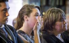 Michaela Holz, daughter of slain Warrant Officer Petrus Holz, wipes away a tear during her father's funeral at the Dutch Reformed Church in Somerset West. Holz was murdered on the N2 when he pulled over after his vehicle hit an obstruction, allegedly placed their by his killers. Picture: Thomas Holder/EWN