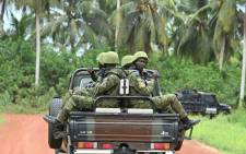 Ivorian soldiers drive on the back of a vehicle outside the International Academy for Combating Terrorism (AILCT) in Jacqueville in Ivory Coast on 10 June 2021. Picture: Issouf Sanogo/AFP