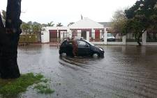 A man pushes a car in a flooded road in Edgemead, Cape Town on 28 August 2013. Picture: Glen De Goede.