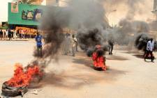 Sudanese protesters burn tyres during a demonstration in Omdurman, the capital's twin city, urging the government to step down over delayed justice and recent harsh economic reforms, on June 30, 2021. The demonstrations were triggered by growing popular discontent against a recent government and after the IMF approved $2.5 billion loan and debt relief deal Sudan that will see the country's external debt reduced by some $50 billion. Picture: Ebrahim Hadim / AFP
