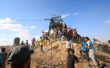 Palestinians gather and react at a Hamas outpost that was struck by Israeli bombardment near Khan Yunis in the southern Gaza Strip on 20 July, 2018. Picture: AFP.