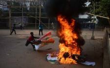 A Bangladeshi youth sets fire to a motorbike during a protest by the Bangladesh Nationalist Party (BNP) in Dhaka on December 29, 2013. Opposition leader Khaleda Zia has said that the government is illegal, undemocratic and should step down immediately. Picture: AFP.