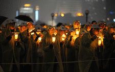 People light candles as they take part in an event to promote "Earth Hour" in the financial district of Shanghai on March 23, 2013. Picture: AFP