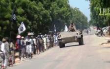 FILE: This screengrab shows Boko Haram fighters parading on a tank in an unidentified town. Picture: AFP.