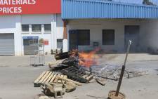 Barricades are seen in a road during a protest in Mbabane, on 21 October 2021. At least 80 people were injured in eSwatini on 20 October 2021, a union leader said, as security forces cracked down on escalating pro-democracy protests in Africa's last absolute monarchy. Picture: AFP