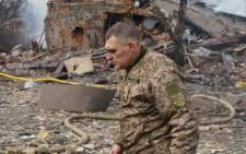 Ukraine army public affairs officer Valentin Yermolenko walks in front of a destroyed shoe factory following an airstrike in Dnipro on 11 March 2022. Picture: Emre Caylak/AFP
