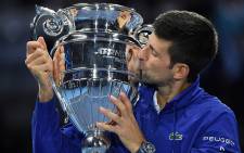 Serbia's Novak Djokovic celebrates with the ATP number 1 player trophy after winning to Norway's Casper Ruud during their single match of ATP Finals' first round at the Pala Alpitour venue in Turin on November 15, 2021. Picture: Marco Bertorello / AFP
