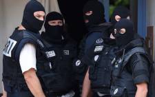 Special forces of France’s Research and Intervention Brigades (BRI) stand outside the apartment of a man suspected of carrying out an attack in Saint-Priest near Lyon on 26 June, 2015. Picture: AFP