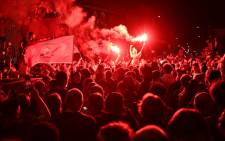 Fans celebrate Liverpool winning the Premier League title outside Anfield stadium in Liverpool, north west England on 25 June 2020, following Chelsea's 2-1 victory over Manchester City. Picture: AFP