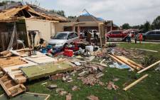 A family van is exposed after the garage was blown apart May 16, 2013 in Cleburne, Texas. A mile-wide tornado passed through the northern Texas suburb Granbury, damaging parts of southwestern Cleburne, and reportedly killing 6 and leaving dozens injured.