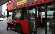 A passenger boards a bus from the front door in central London on April 8, 2020. Picture: AFP.