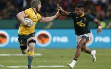 FILE: Australia's David Pocock (L) holds off South Africa's Aphiwe Dyantyi during the Rugby Championship match between South Africa and Australia at Nelson Mandela Bay Stadium in Port Elizabeth, South Africa, on 19 September 2018. Picture: AFP