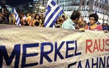Greek protestors gather in Athens to demonstrate against the state visit of German Chancellor Angela Merkel on 9 October, 2012 as the euro economic crisis worsens. Picture: AFP.