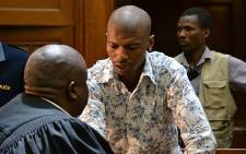 Xolile Mngeni consults with his lawyer on 19 November 2012 in the Western Cape High Court right after hearing that he had been found guilty of the murder of Anni Dewani. Picture: Aletta Gardner/EWN