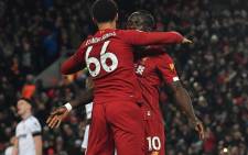 Liverpool's Senegalese striker Sadio Mane (R) celebrates with Liverpool's English defender Trent Alexander-Arnold after scoring his team's third goal during the English Premier League football match between Liverpool and West Ham United at Anfield in Liverpool, north west England on 24 February 2020. Picture: AFP