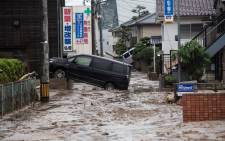 A picture shows cars trapped in the mud after floods in Saka, Hiroshima Prefecture on 8 July 2018. Picture: AFP.