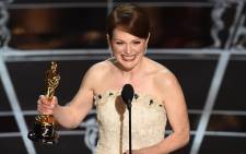 Winner for Best Actress Julianne Moore accepts her award on stage at the 87th Oscars February 22, 2015 in Hollywood, California.  Picture: AFP.