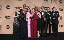 The cast of 'Downton Abbey' pose with the actor for outstanding performance by an ensemble in a drama series room at the 22nd Annual Screen Actors Guild Awards in January 2016. Picture: AFP.
