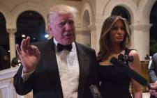 US President-elect Donald Trump answers questions from reporters accompanied by his wife Melania for a New Year's Eve party 31 December, 2016 at Mar-a-Lago in Palm Beach, Florida. Picture: AFP.