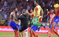 Costa Rica's Kendall Waston celebrates with teammates after qualifying for the 2018 World Cup, in San Jose on 7 October 2017. Picture: AFP.

