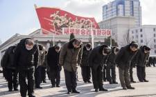 People bow during a three minutes silence to pay their respects towards portraits of Kim Il Sung and Kim Jong Il, to mark the ten year anniversary of the death of Kim Jong Il, the father of current leader Kim Jong Un, at Kim Il Sung Square in Pyongyang on 17 December 2021. Picture: Kim Won Jin/AFP